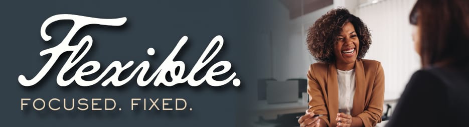 A smiling African American woman speaking to someone at her desk. To the left, the words: flexible focused fixed.